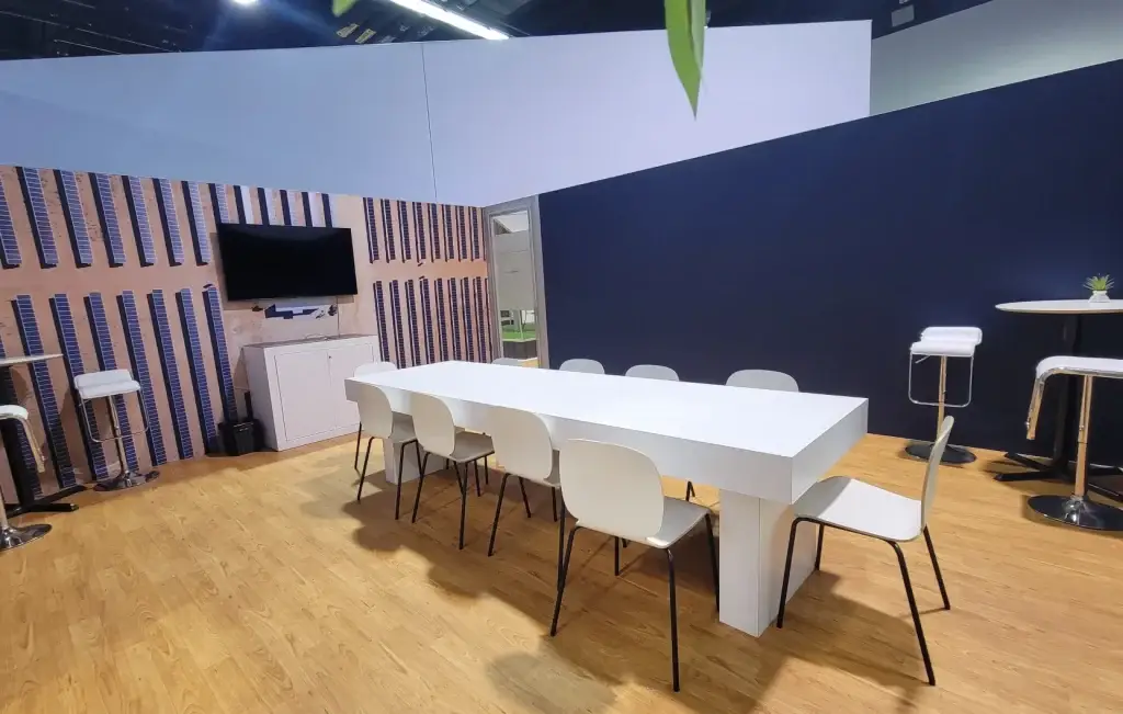 Spacious and inviting empty networking area within Array Technologies' trade show booth, designed for attendee interactions.