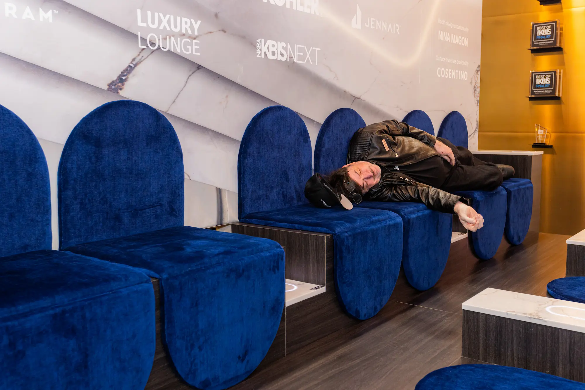 Exhibitor relaxing after KBIS and IBS trade show inside luxury lounge, symbolizing post-show success and digital marketing follow-up opportunities.