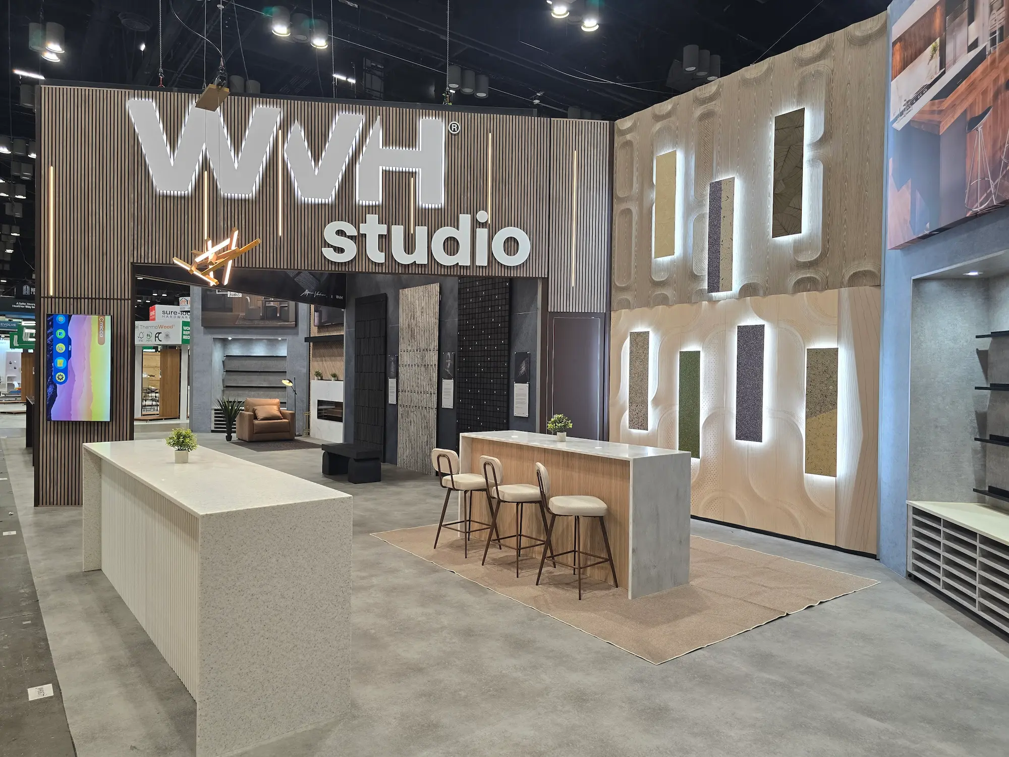 WVH Studio trade show booth showcasing premium finish quality with textured materials and integrated lighting