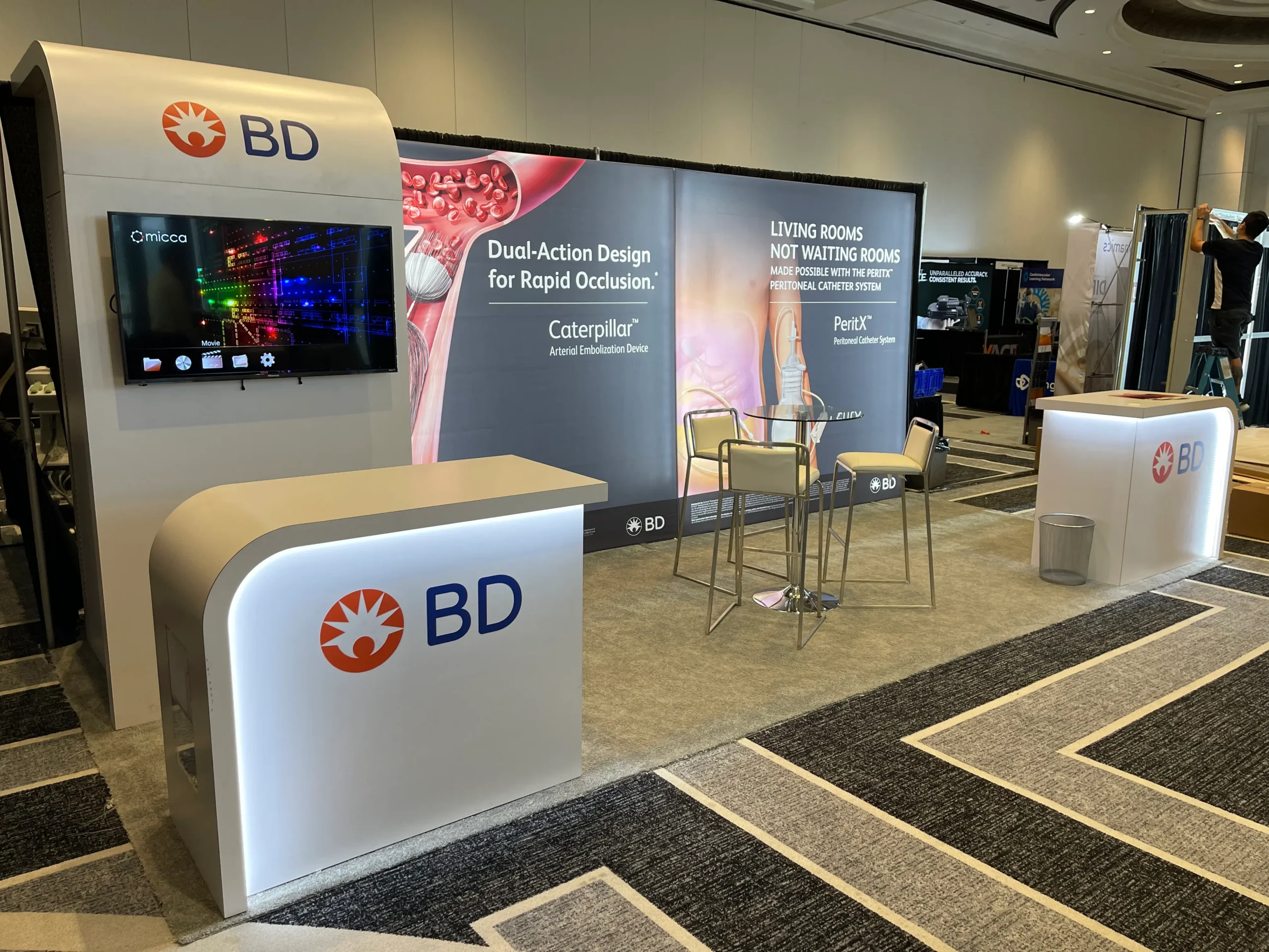 BD 10x20 trade show booth with curved counters and large format graphics