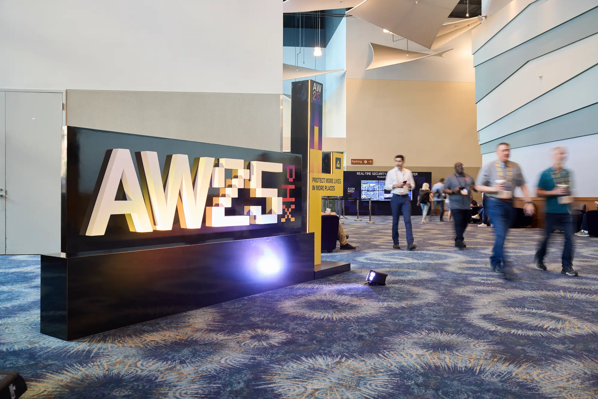 Axon Week 2025 custom fabricated entrance sign with dimensional letters and uplighting produced by Highway 85 Productions