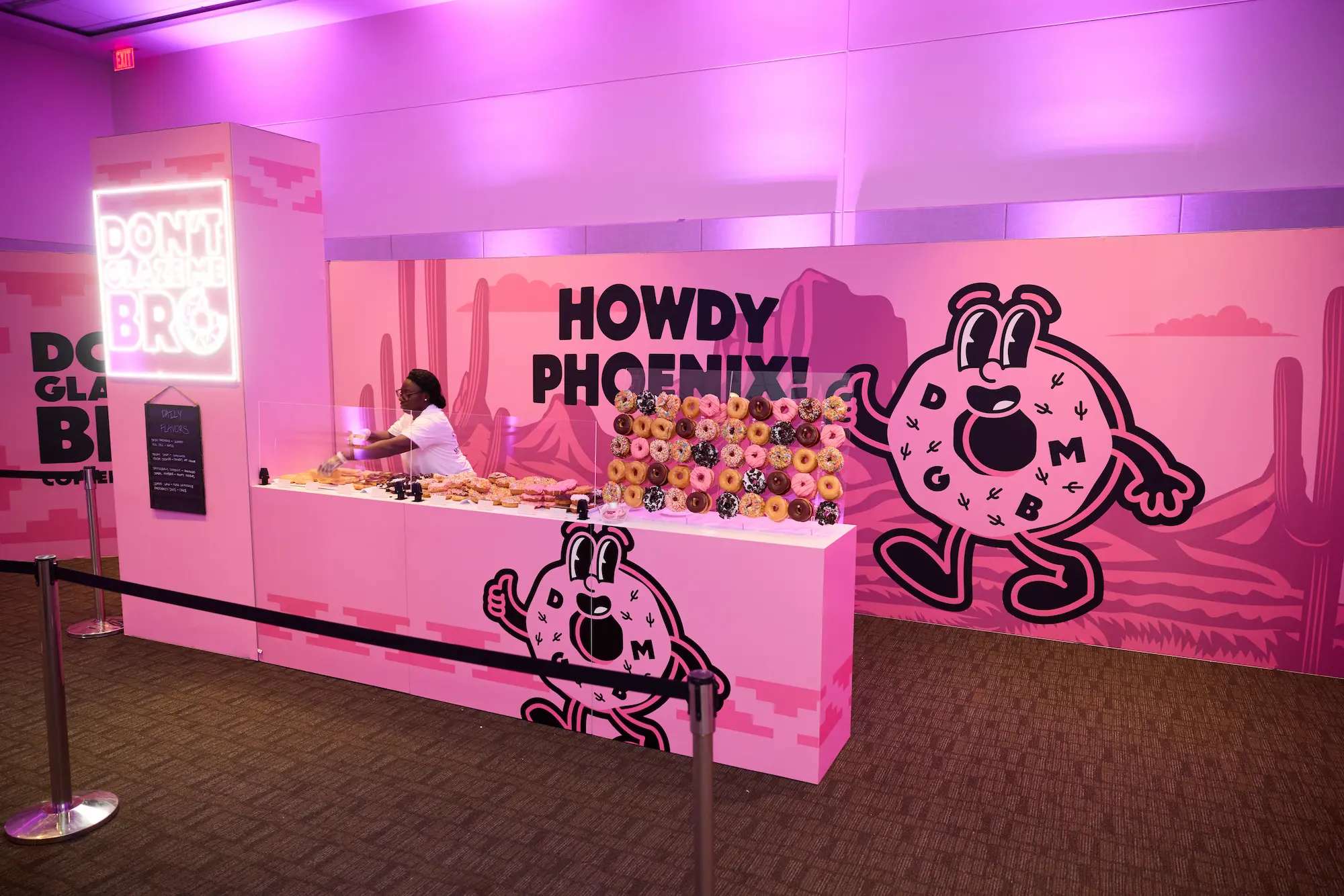 Don't Glaze Me Bro branded donut and coffee activation with custom fabricated counter, neon signage, and large format wall graphics at Axon Week 2025 produced by Highway 85 Productions