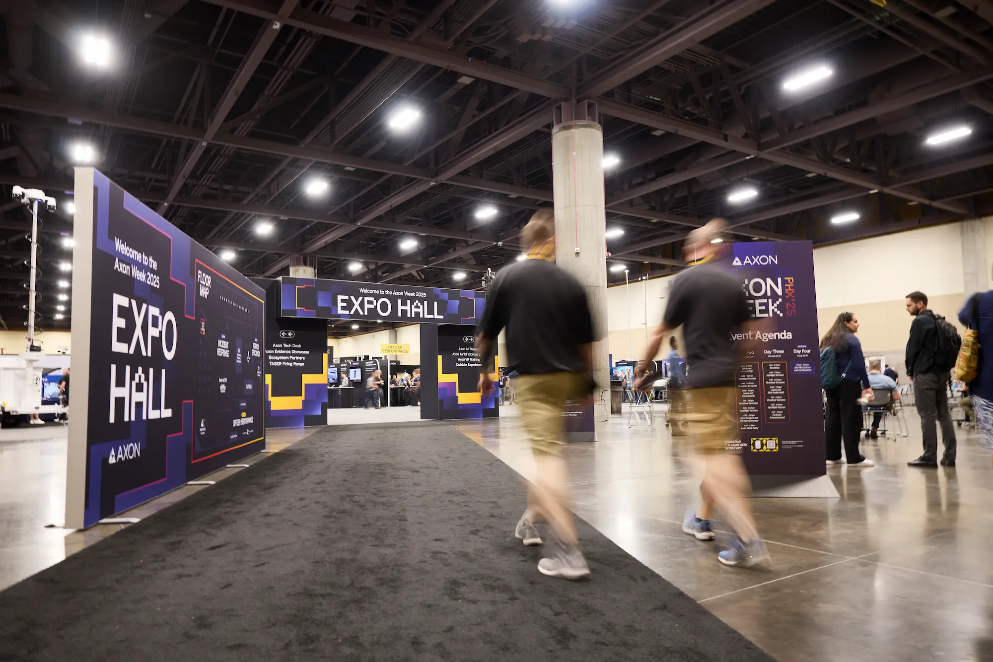 Axon Week 2025 Expo Hall entrance with branded signage and event agenda displays produced by Highway 85 Productions
