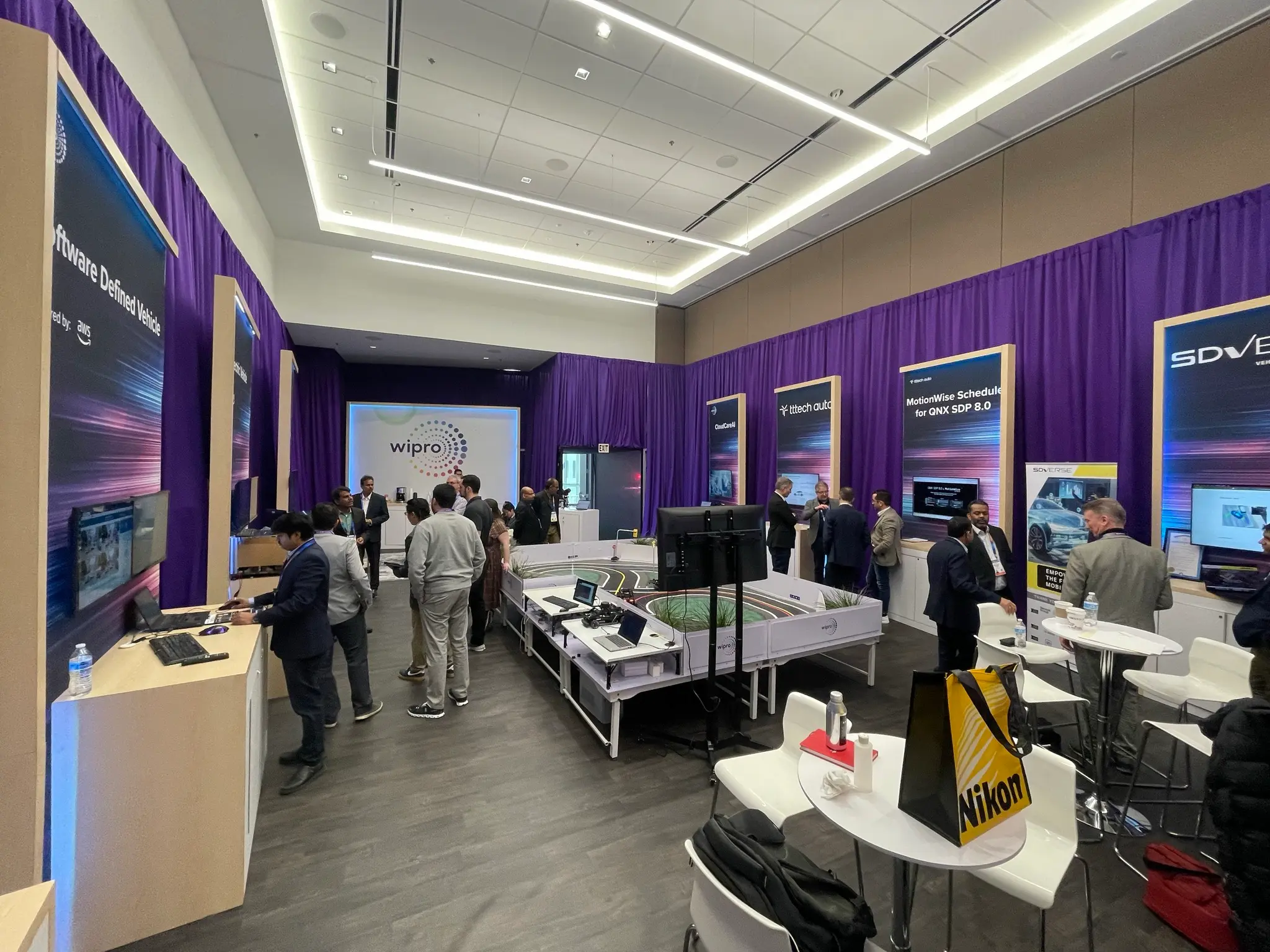 Wipro external corporate event strategy showcased through branded meeting room with interactive product displays and immersive signage produced by Highway 85 Productions