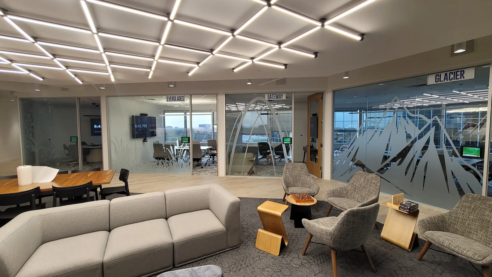 Full commercial interior branding project with branded glass film conference rooms, themed wayfinding signage, and permanent installation by Highway 85 Productions