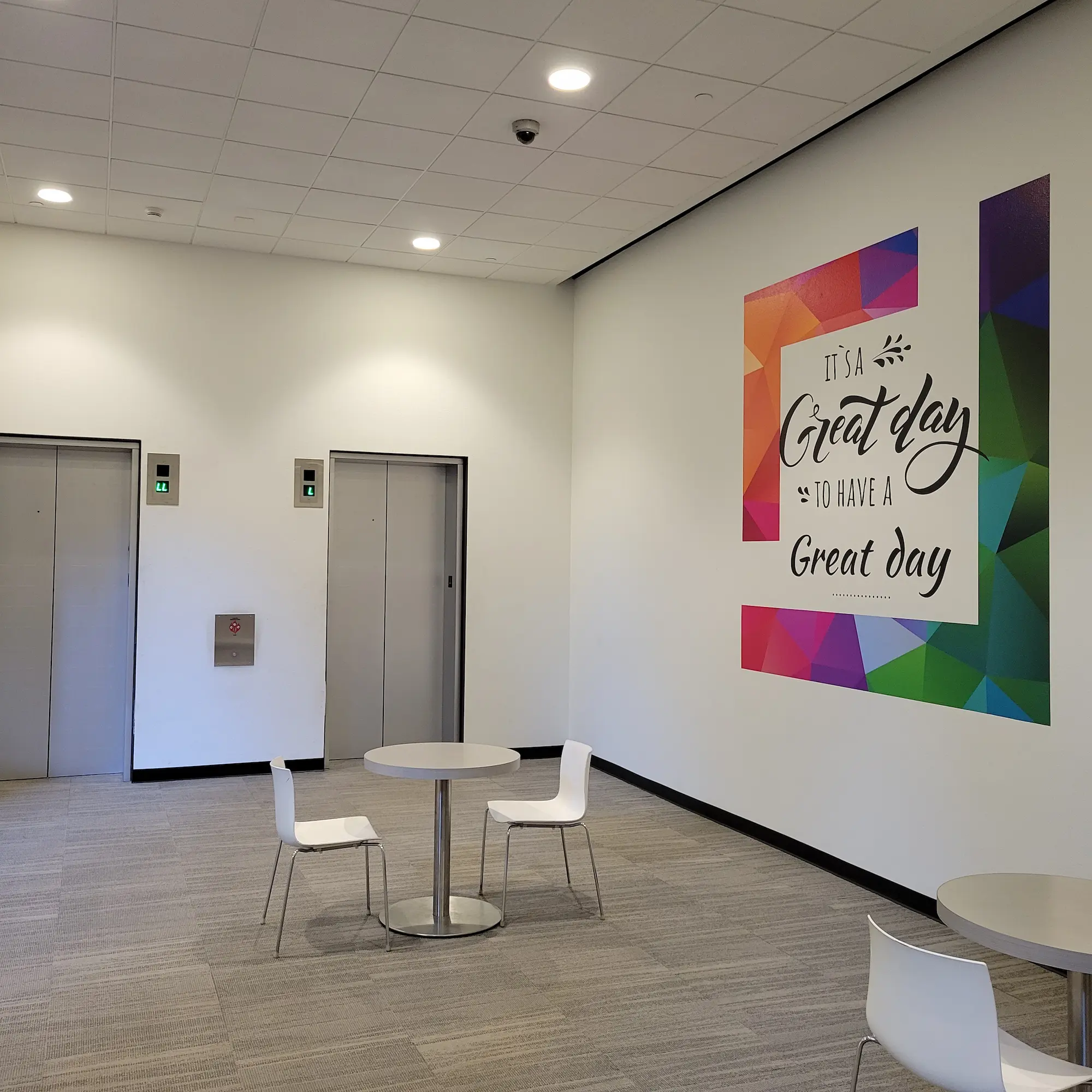 Office interior with branded hallway graphics and colorful motivational wall graphic installation by Highway 85 Productions