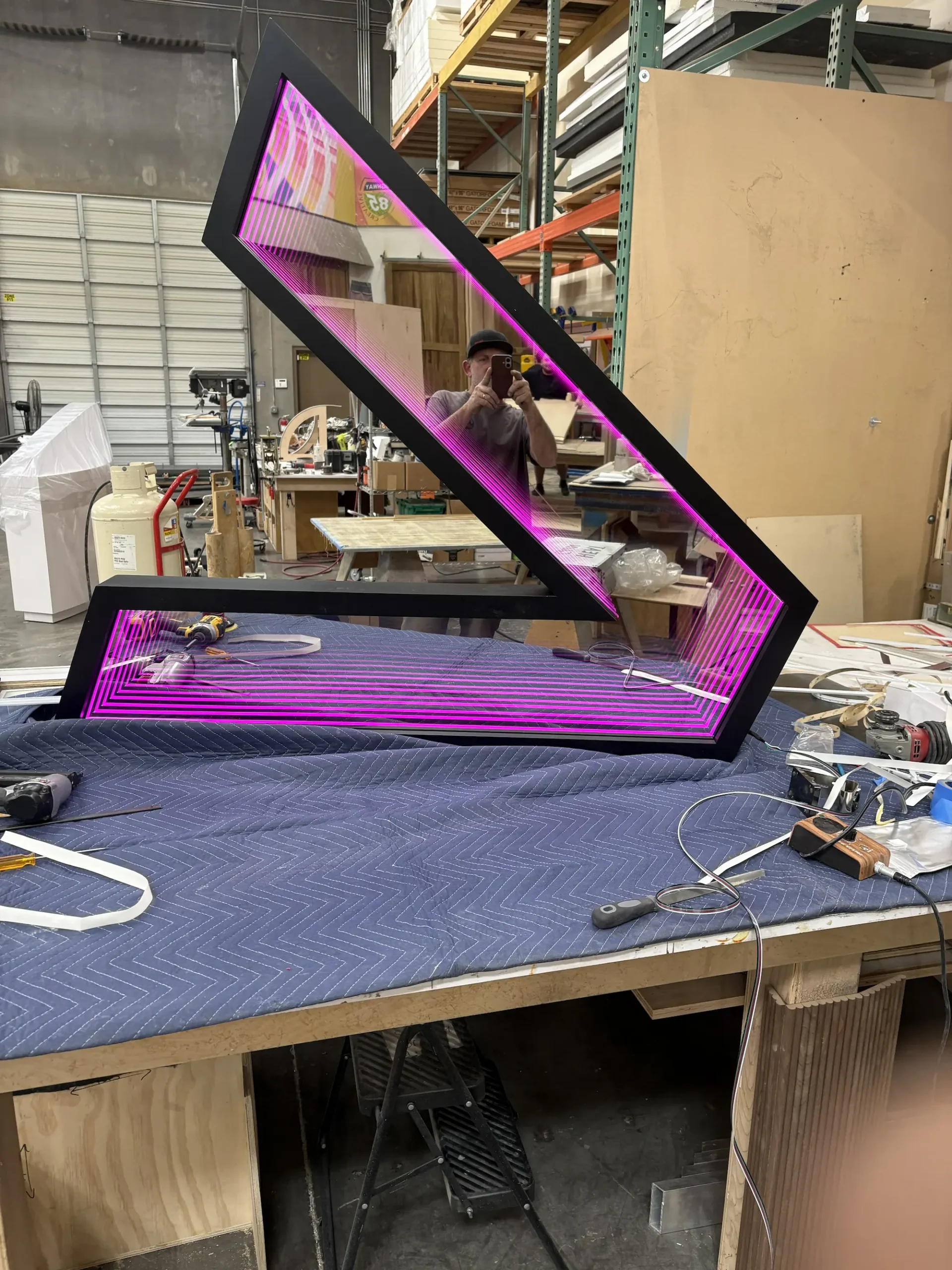 Accenture custom infinity mirror logo installation being fabricated in the Highway 85 Productions shop as part of a permanent commercial interior project