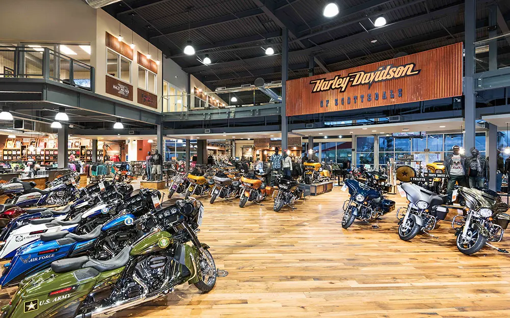 Harley-Davidson of Scottsdale dealership interior branding with custom dimensional logo wall, warm wood finishes, and permanent commercial installation by Highway 85 Productions
