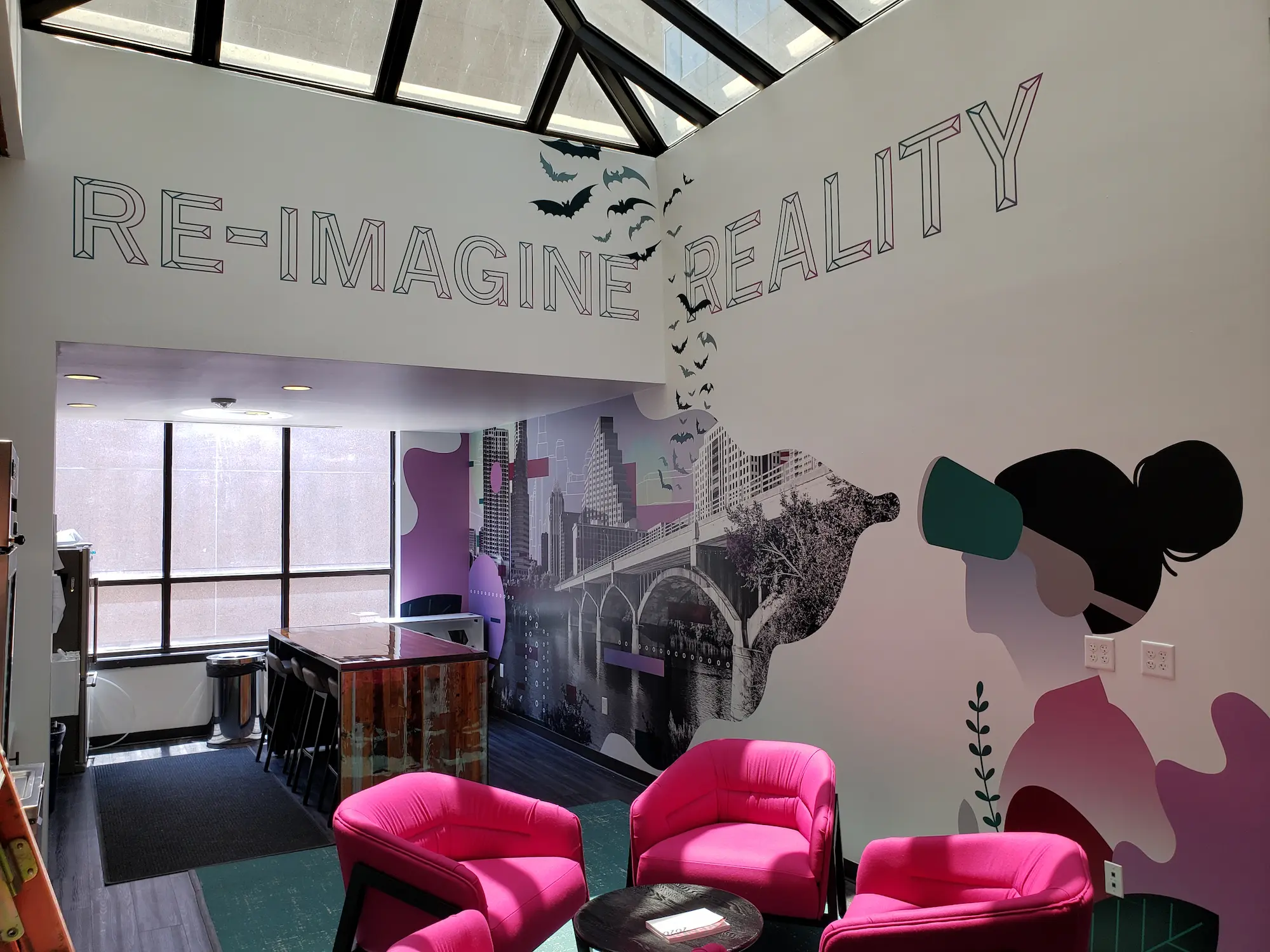 Re-Imagine Reality office interior with large format branded wall mural, environmental graphics, and permanent commercial installation by Highway 85 Productions