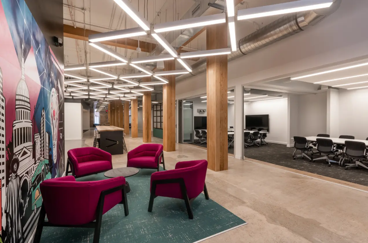 Office interior with custom lobby feature wall mural, branded lounge seating area, and permanent commercial installation by Highway 85 Productions