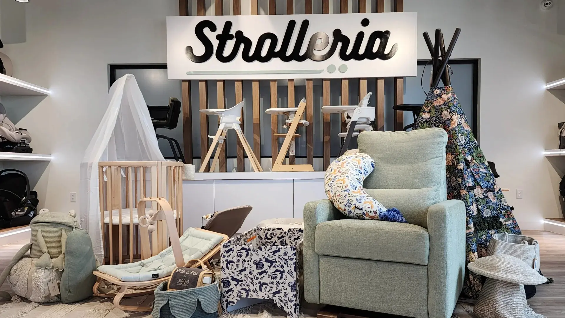 Strolleria retail store dimensional letter signage with custom fabricated logo wall and branded interior installation by Highway 85 Productions