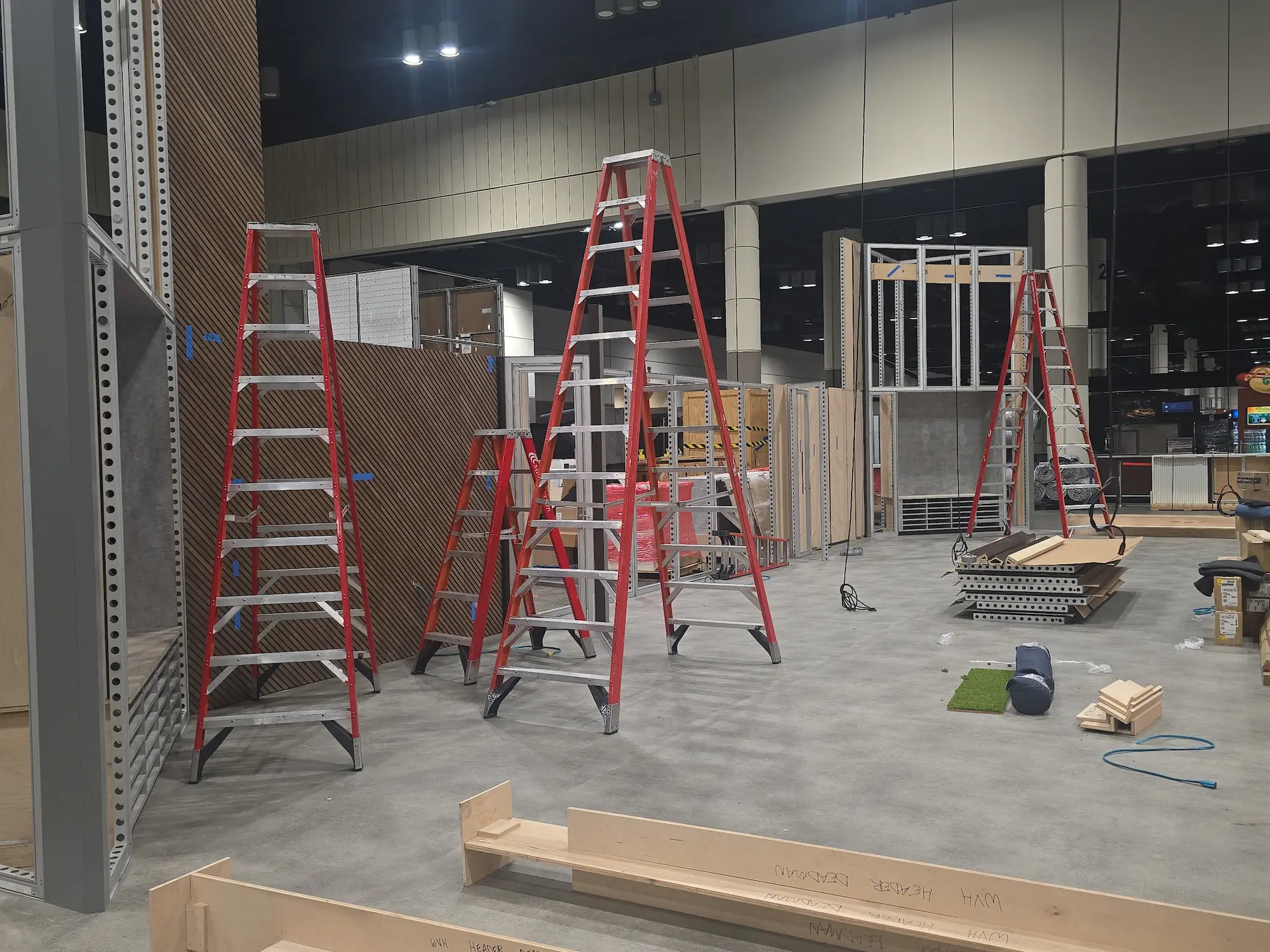 Highway 85 Productions install crew setting up custom fabricated trade show booth components on the show floor for an agency client fabrication project