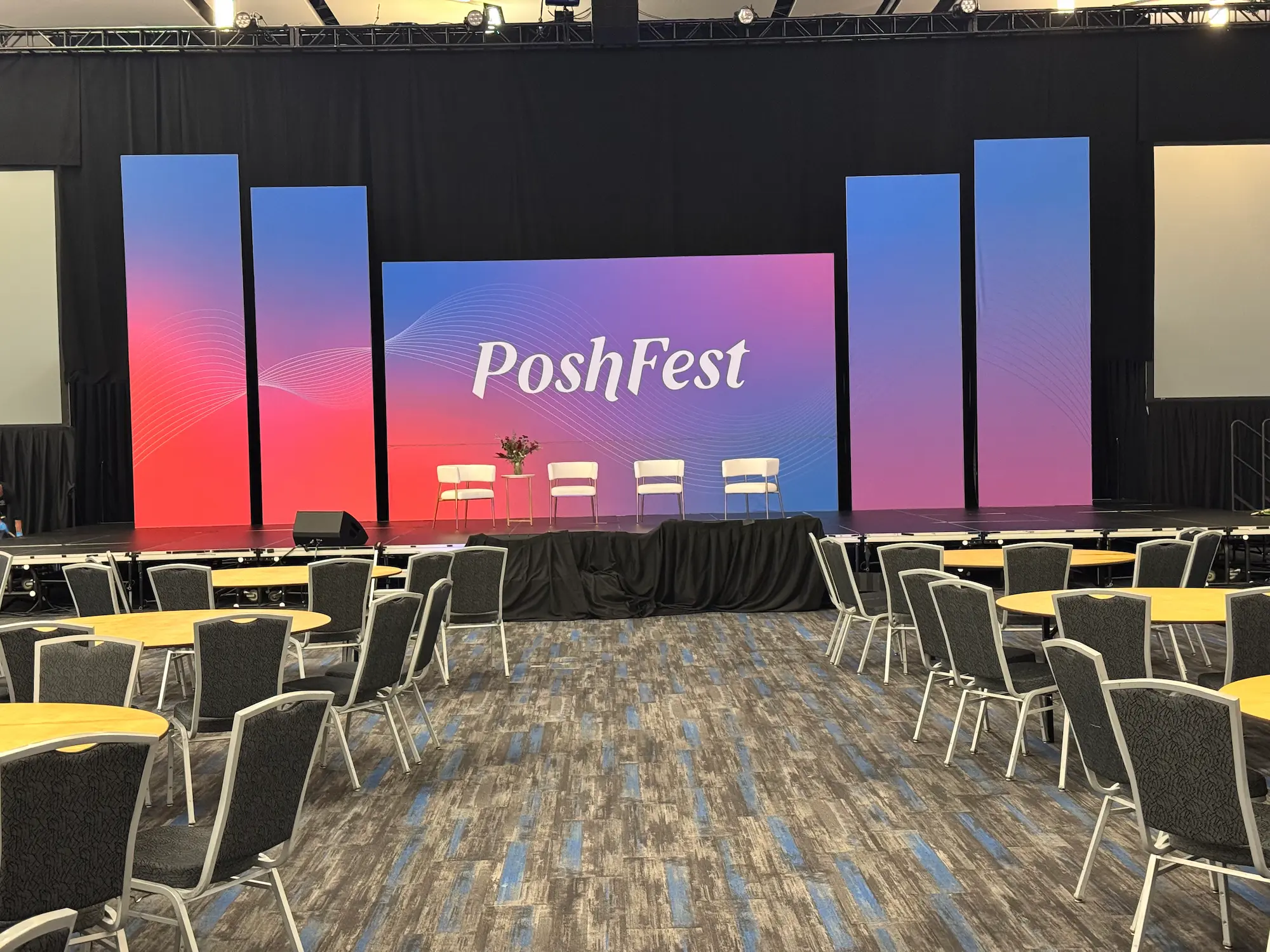 PoshFest branded corporate event stage with custom fabricated LED backdrop panels produced by Highway 85 Productions for an agency client