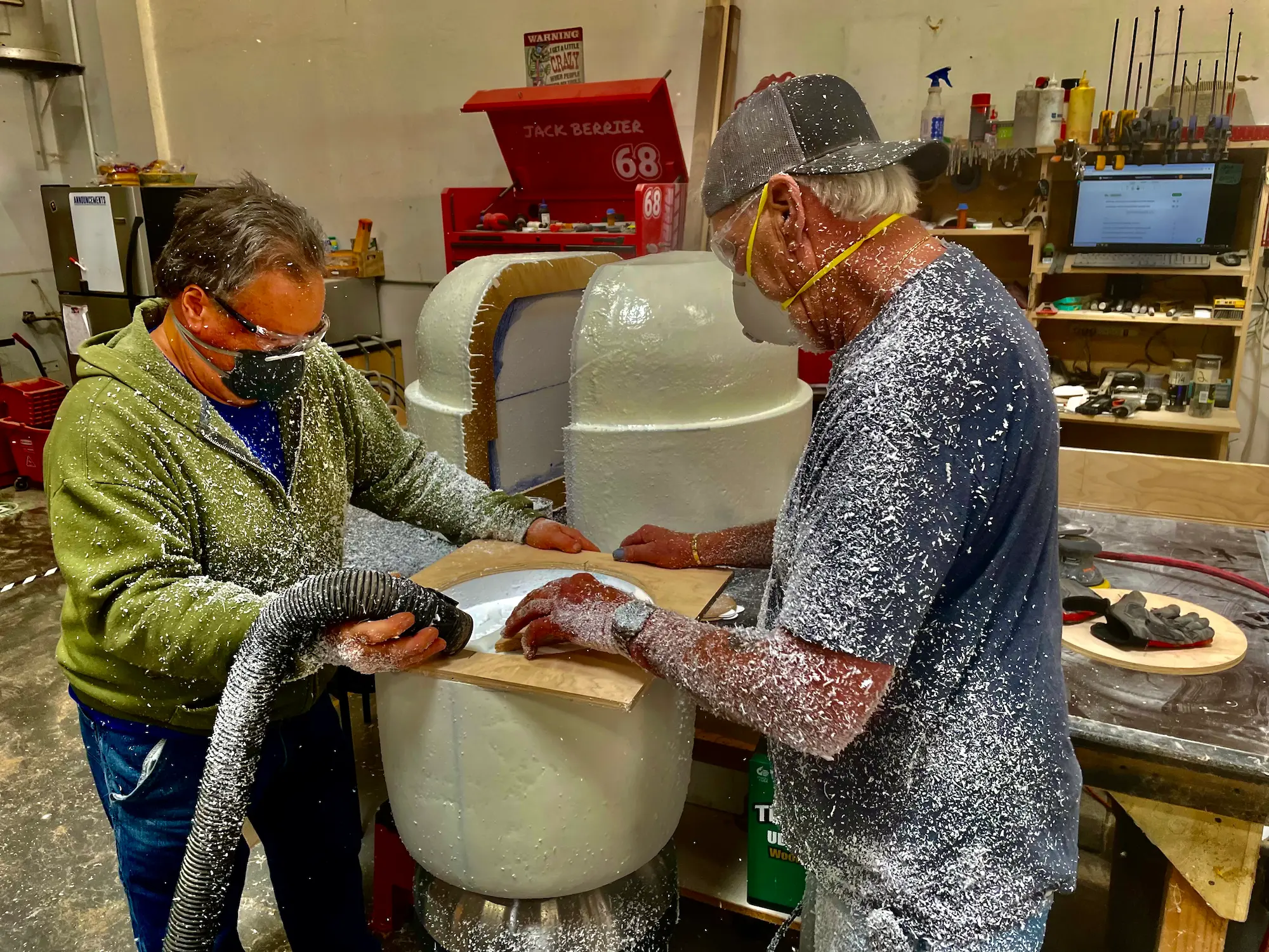Highway 85 Productions fabrication team sculpting custom foam elements in the shop for a white label fabrication project