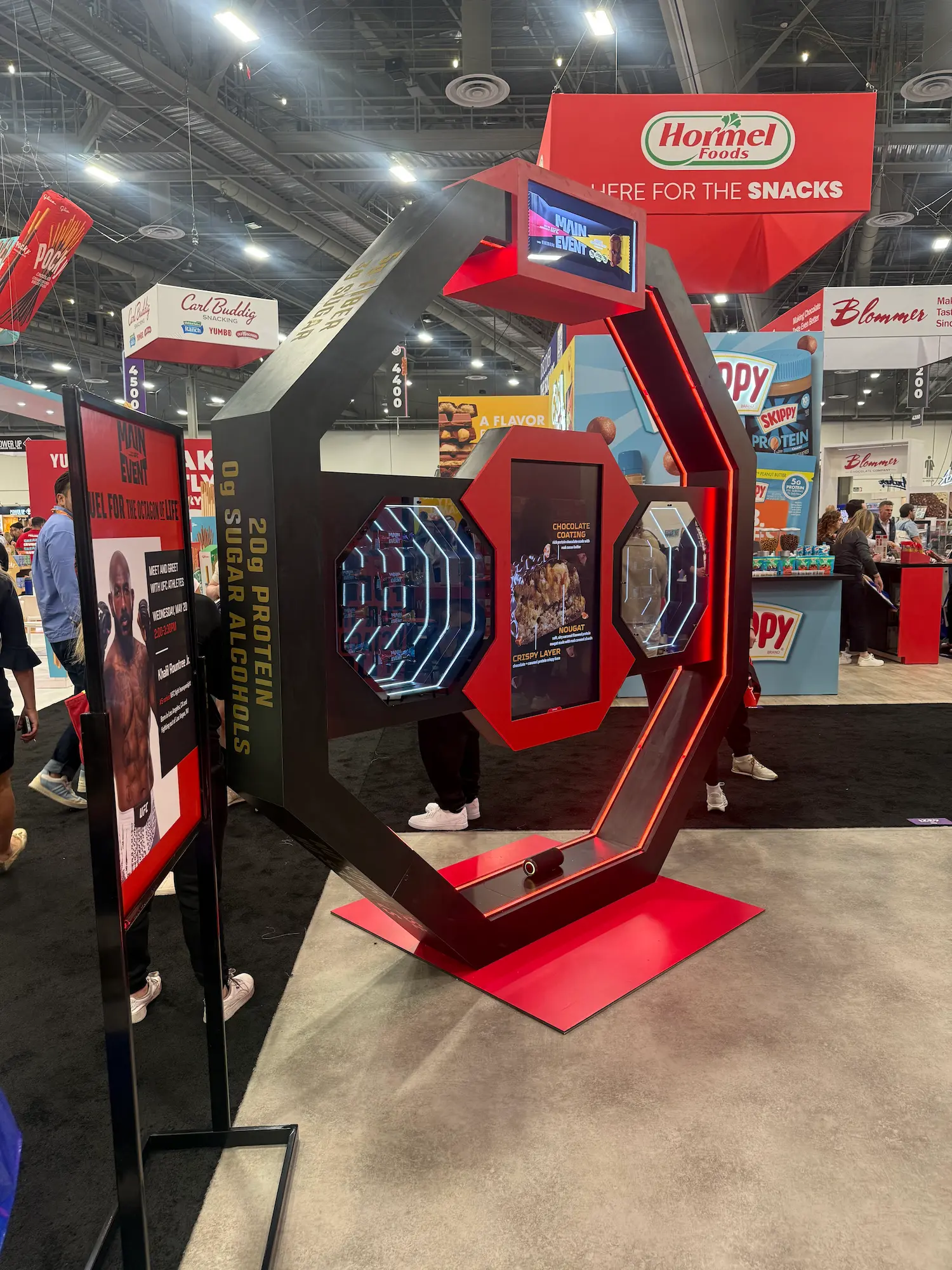 Main Event UFC custom trade show booth with octagon shaped interactive display and LED lighting showing why brands invest in a custom trade show booth by Highway 85 Productions