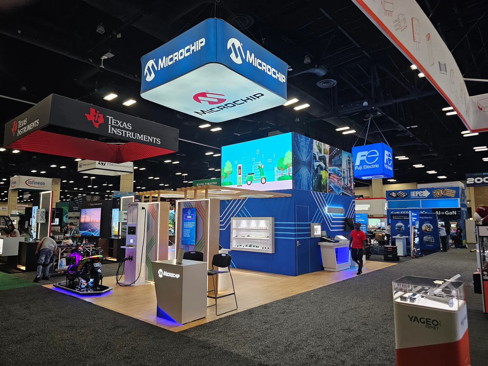 Microchip Technology 20x40 custom trade show booth with overhead hanging sign, LED walls, and integrated trade show booth lighting by Highway 85 Productions
