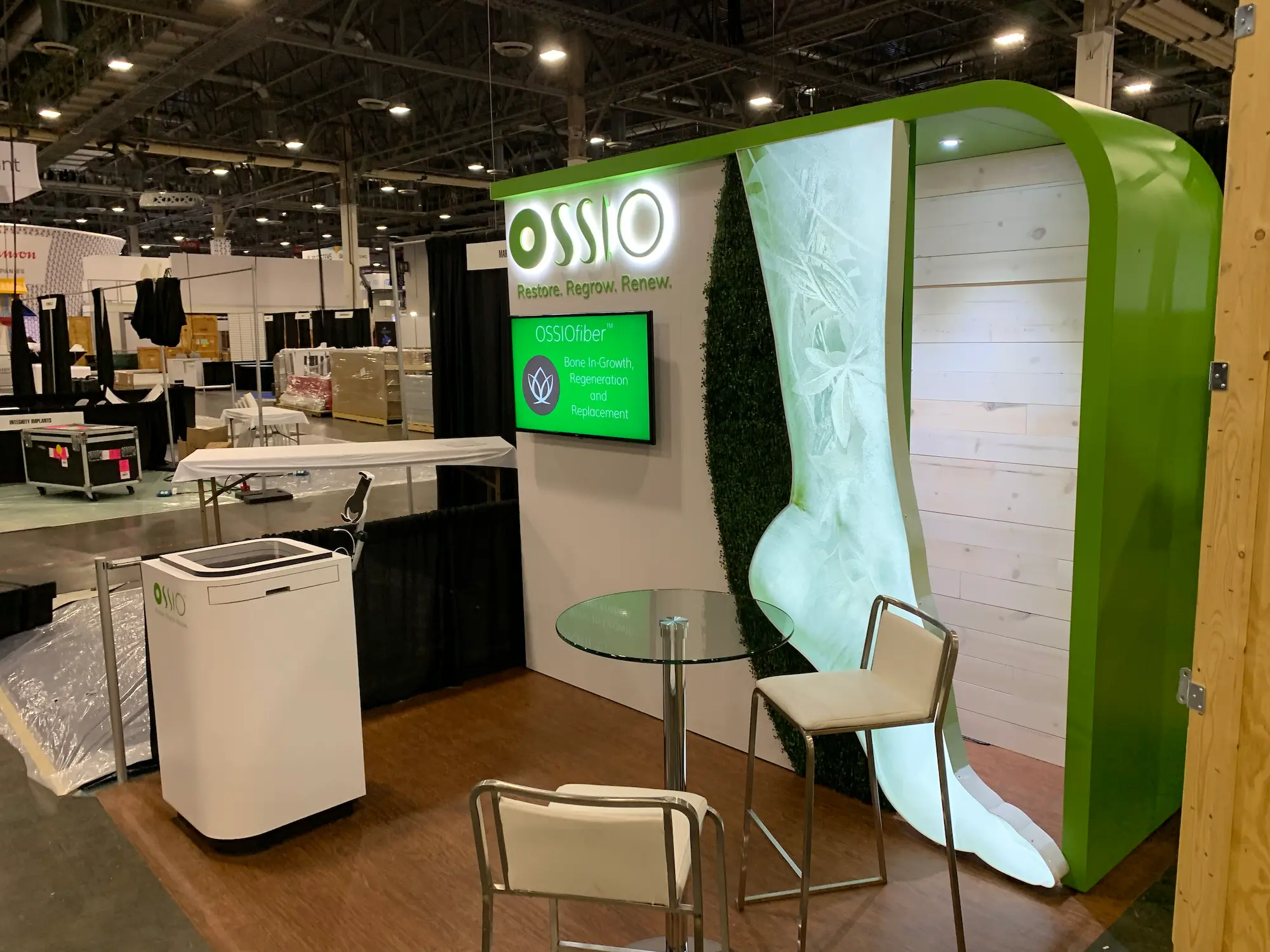 Ossio custom 10x10 trade show booth showing what a realistic first trade show cost investment looks like on the show floor by Highway 85 Productions